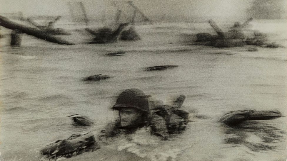 Normandy invasion on D-Day, soldier advancing through surf, 1944 by Robert Capa