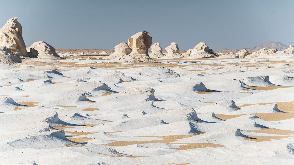 The White Desert in Egypt has mushroom-shaped formations made of white limestone