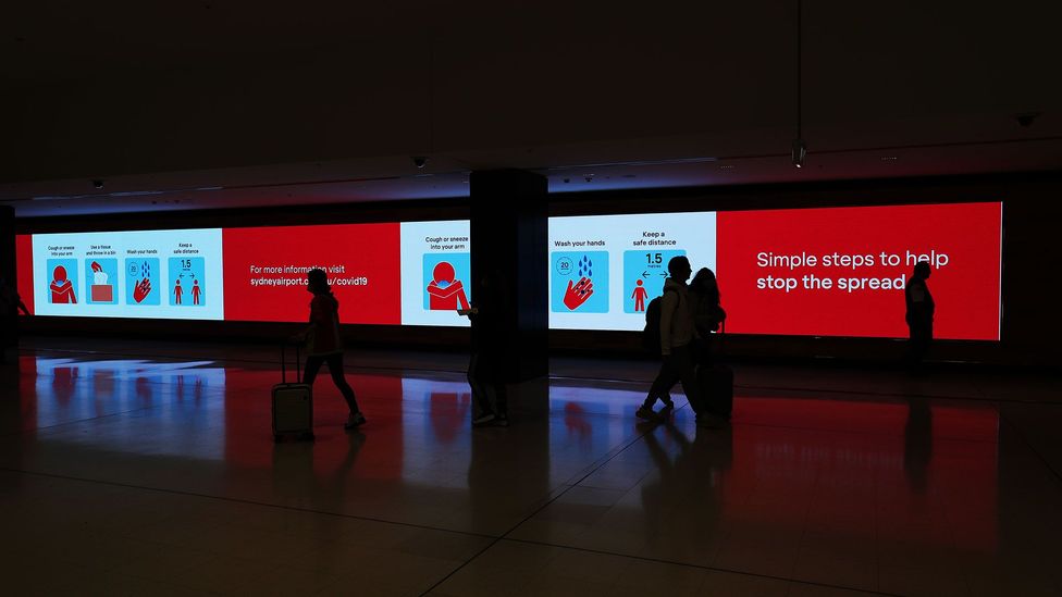 Warnings greet travellers at Sydney International Airport. From Wednesday 25 March, all international travel to Australia was banned (Credit: Getty Images) Warnings greet travellers at Sydney International Airport. From Wednesday 25 March, all international travel to Australia was banned (Credit: Getty Images)