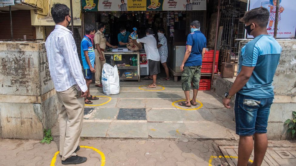 Authorities are teaching Indians how to queue at healthy social distances with chalk-drawn circles (Credit: Hindustan Times/Getty Images)
