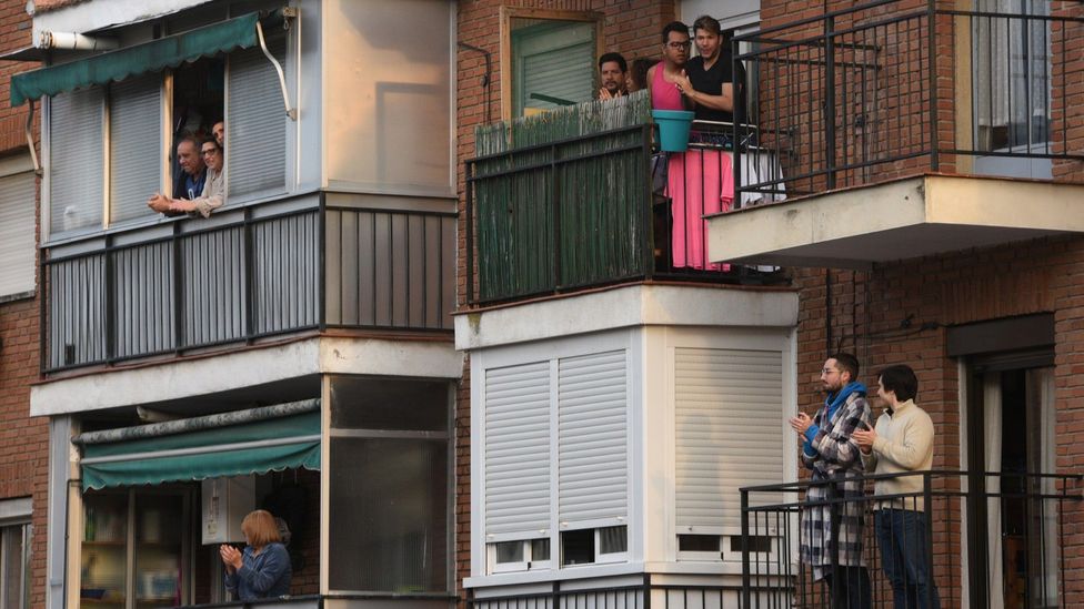 Residents applaud healthcare workers from their balconies in Madrid on 29 March 2020