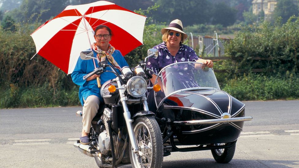 The Two Fat Ladies, aka Clarissa Dickson-Wright and Jennifer Paterson, roared around the UK on a motorbike and sidecar, and like Floyd brought verve to food TV (Credit: Alamy)