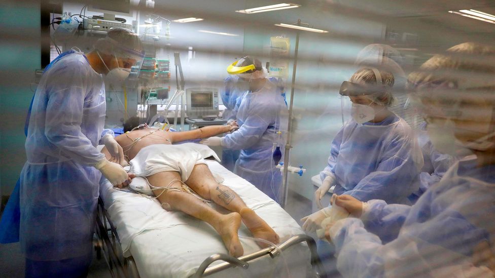 Medical workers care for a Covid-19 patient in Porto Alegre, Brazil; some patients recover in two days, while others take months (Credit: Reuters)