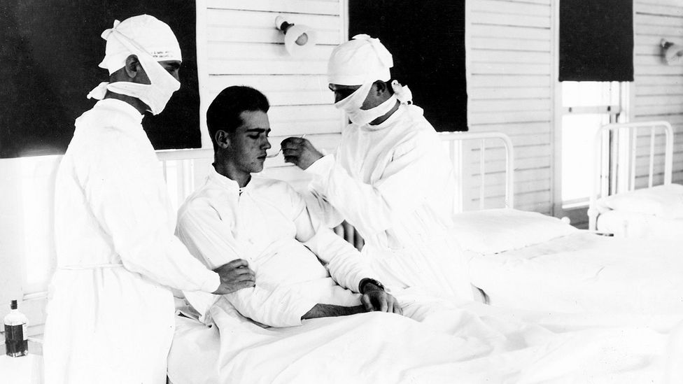 Doctors treat an influenza patient in New Orleans in 1918; some five million survivors of the pandemic experienced a long-term state of extreme exhaustion (Credit: Getty Images)