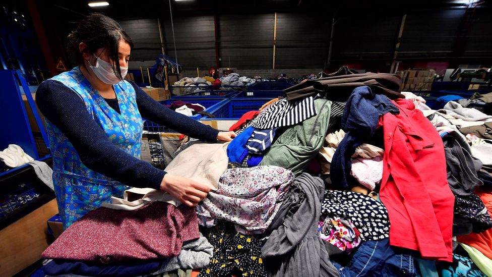 Sorting clothing by hand is a time consuming task made more complicated by the many blends of man-made and natural fibres used in modern garments (Credit: Getty Images)