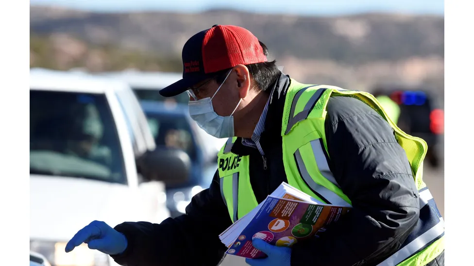 Navajo Nation President Jonathan Nez distributes educational material to drivers on how to prevent the spread of Covid-19 (Credit: Reuters) Navajo Nation President Jonathan Nez distributes educational material to drivers on how to prevent the spread of Covid-19 (Credit: Reuters)