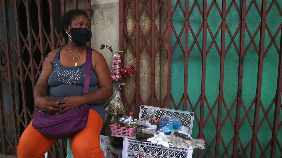 A member of the Ati indigenous community sells amulets and ointments containing parts of trees and rocks in Iloilo (Credit: Arnel Murga)