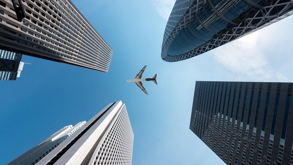 File image of a plane flying over skyscrapers