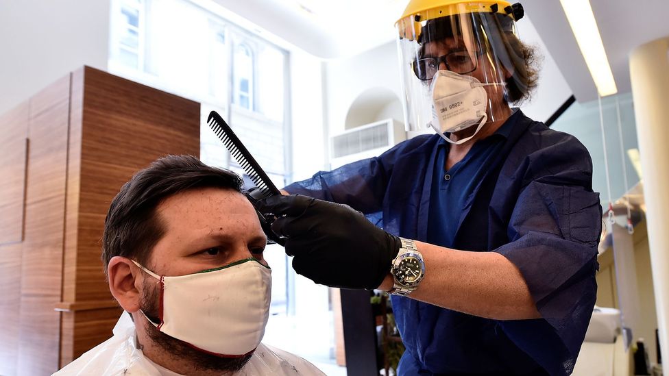 Many businesses that involve close contact with customers, such as hairdressers and barbers, are giving their staff face shields to wear (Credit: Reuters)