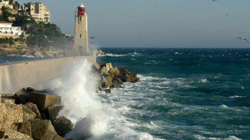 Concrete walls are an easy way to bolster the coastline from the sea, but the environmental impact of using this material is huge (Credit: BBC)