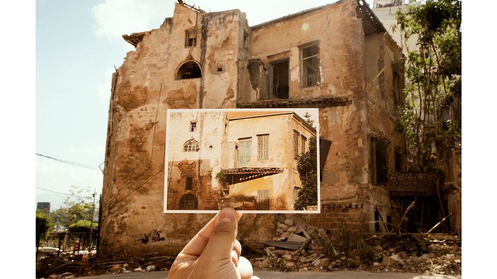 A new series of photographs shows Khoury and Cardozo holding up their postcards in front of the structures shattered by the explosion (Credit: Joseph M Khoury)