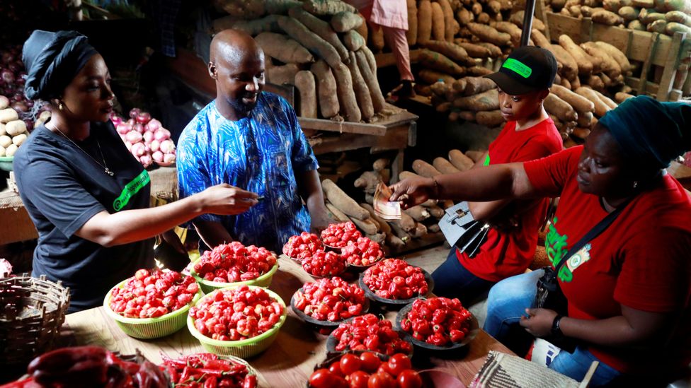 A market in Lagos, Nigeria, where Pidgin English helps people communicate with a common language (Credit: Reuters)