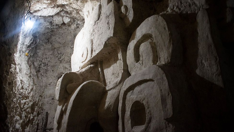 A Maya carving dating to the 5th Century AD looms out of the dark at El Zotz (Credit: Amanda Ruggeri)