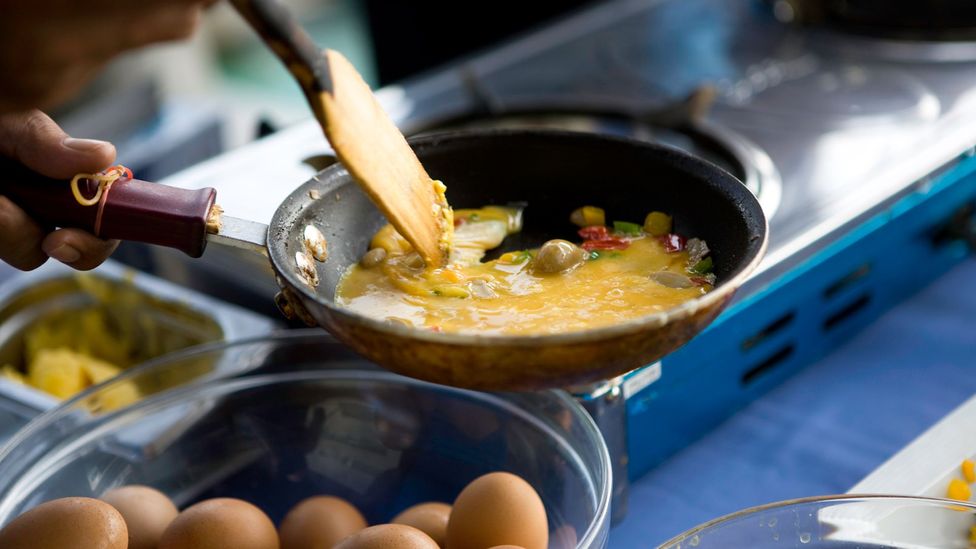 Frying an omelette or making breakfast can release a surprising amount of tiny pollutant particles known as PM2.5s (Credit: Getty Images)