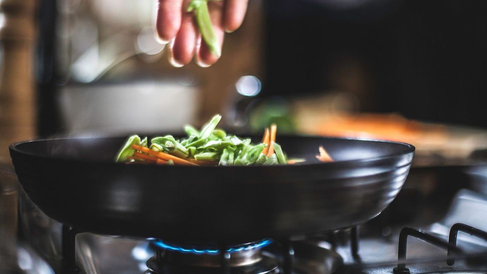 Experts recommend using an extractor fan when cooking due to the spike in air pollution the activity causes (Credit: Getty Images)