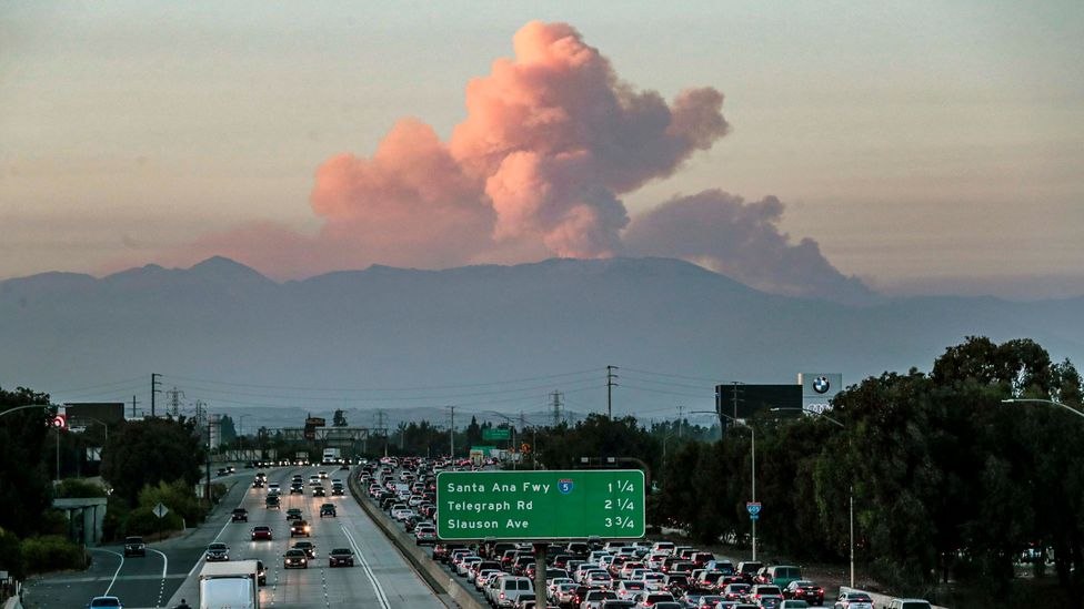 A wildfire cloud looms over Californian traffic, earlier this month (Credit: Getty Images)