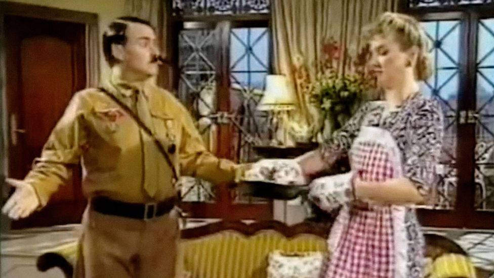 The premise of Heil Honey I'm Home! saw Hitler and Eva Braun clash with their Jewish next door neighbours in a stylised parody of 1950s US sitcoms (Credit: Sky)