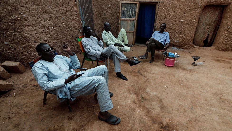 Niger men choose to gather in the streets around a tea kettle rather than indoors (Credit: Reuters/Alamy)