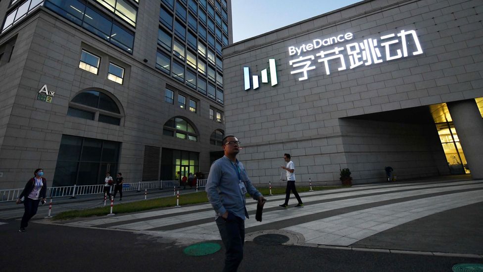 People walk past the Beijing headquarters of ByteDance, which owns TikTok, in September 2020 (Credit: Greg Baker/Getty Images)