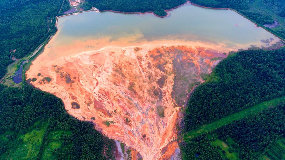 Orange water fans out over the forested landscape near a disused copper-sulphide mine near the village Lyovikha in the Urals, Russia (Credit: Sergey Zamkadniy/Getty Images)