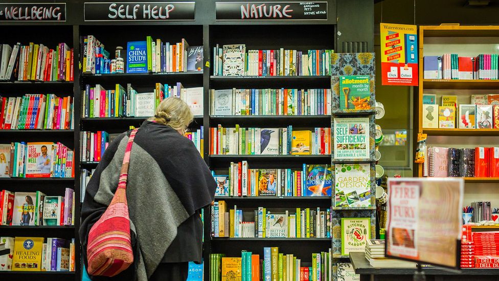 Entire sections of book shop shelving are often dedicated to self-help books that promise to make us happier (Credit: Gerry Walden/Alamy)