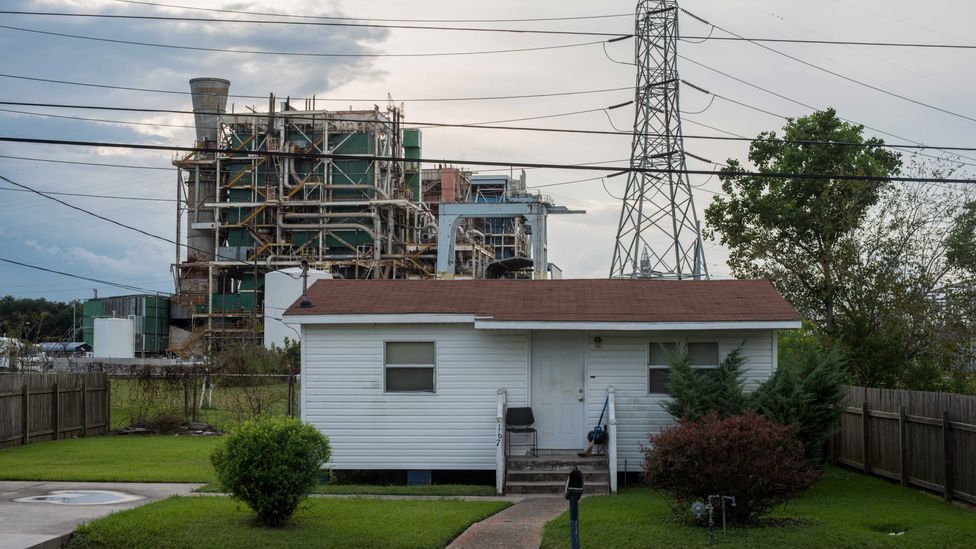 Not far from the Mississippi River, a home in Louisiana sits side-by-side with a chemical plant and pylon (Credit: Giles Clarke/Getty Images)