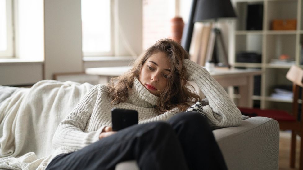 File image of a bored woman looking at her phone