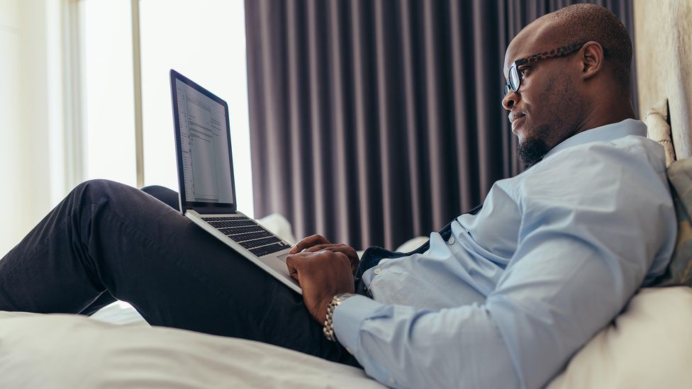 Not only does working from your bed spell potential ergonomic disaster, but it can rewire your brain to disassociate your bed with sleep (Credit: Alamy)