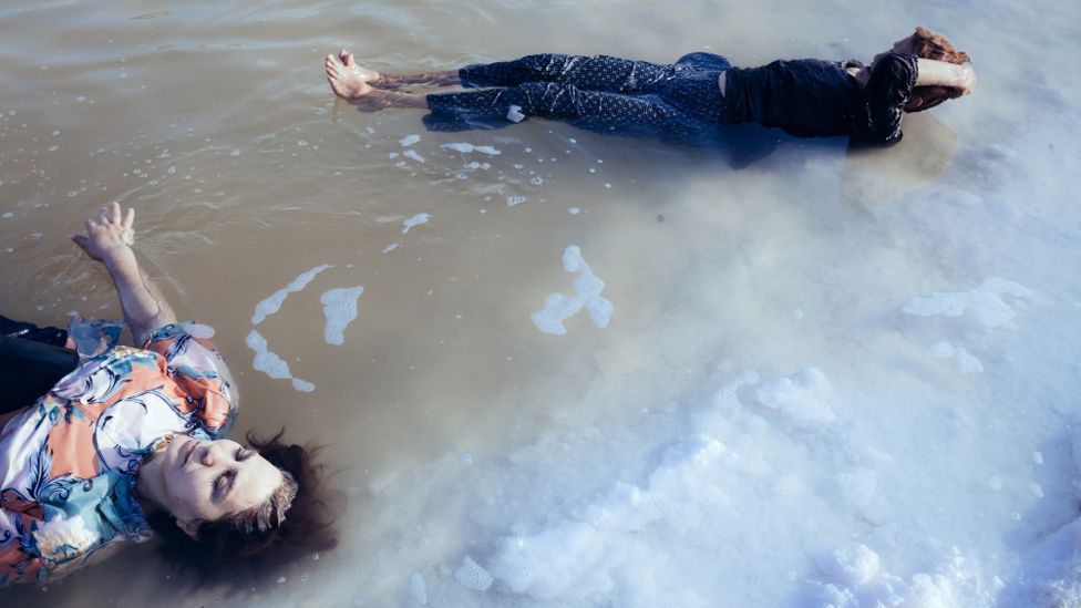 Women bathe in a remant of the lake in 2014, in a remote region of Lake Urmia that now receives few visitors (Credit: Solmaz Daryani)