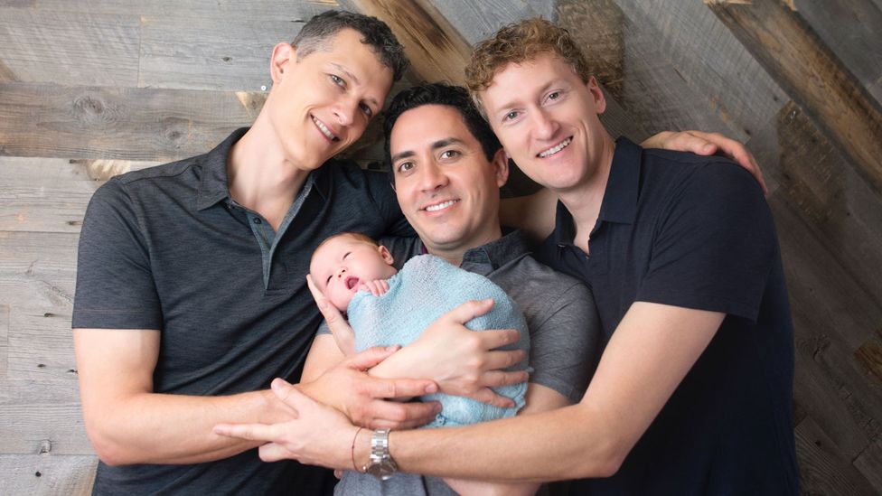 Ian Jenkins (left), along with partners Alan (centre) and Jeremy (right), of California, are all legal parents to their first child, born in 2017 (Credit: Sweet Me Photography)