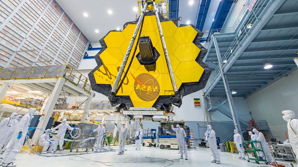 The James Webb Space Telescope’s 18-segmented gold mirror will capture infrared light from some of the first galaxies that formed (Credit: NASA/Desiree Stover)