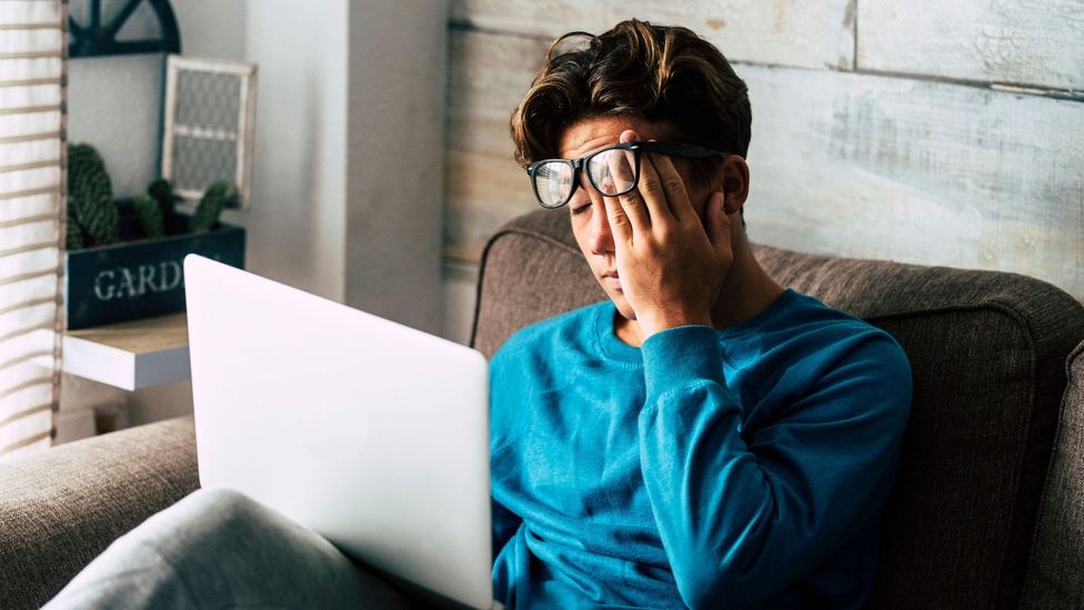 Tired woman staring at laptop