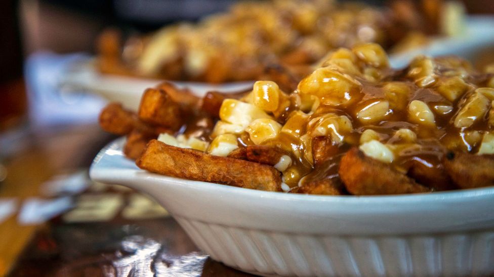 The beloved comfort food poutine is a combination of French fries, cheese curds and a rich meaty gravy (Credit: JML Images/Getty Images)