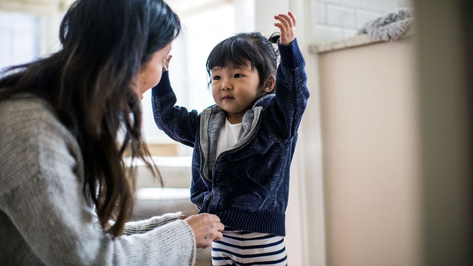 Mothers doing tasks like picking a child's outfits are examples of "maternal gatekeeping" – subtle tasks that fall to mums to take the lead on (Credit: Getty Images)