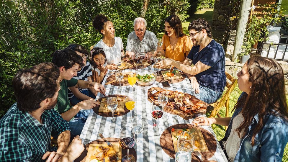 In Argentina, people invite each over for an asado, a traditional South American barbecue (Credit: Johnce/Gety Images)