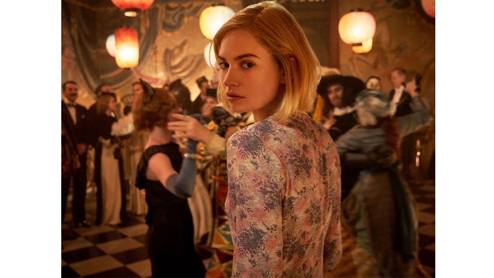 In Daphne du Maurier's Rebecca, the protagonist wears an ill-advised dress to a party – with disastrous consequences (Credit: Kerry Brown/ Netflix)