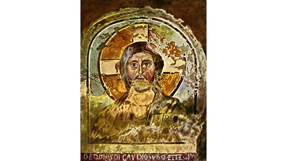 Jesus is sometimes shown with a cruciform halo, as in this early Christian fresco in the Ponzianus catacomb, Rome (Credit: Alamy)