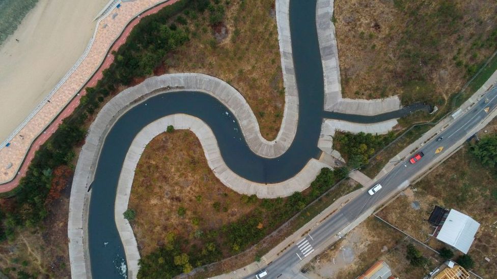 From the air, it looks like the bend of a river, but it is a concrete canal near the coast of Chile to mitigate tsunamis (Credit: Guillermo Salgado/Getty Images)