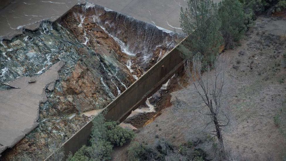 Eroded concrete causes flooding from the Oroville Dam spillway in California (Credit: Kelly M. Grow/Getty Images)