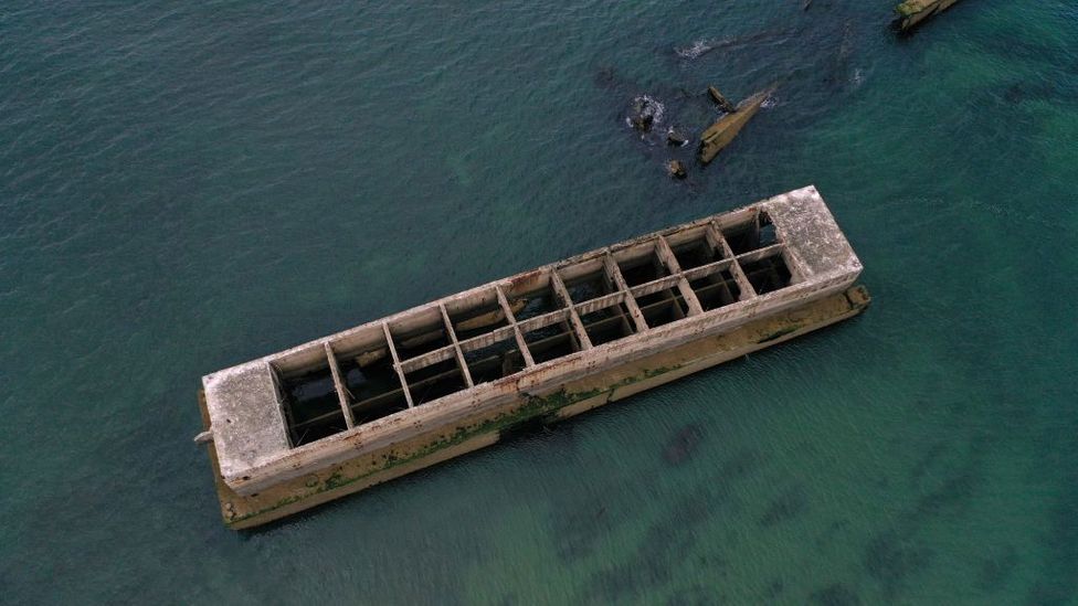 The ocean laps against the temporary Mulberry harbour, placed on the French coast during WWII to allow rapid offloading of cargo (Credit: Damien Meyer/Getty Images)