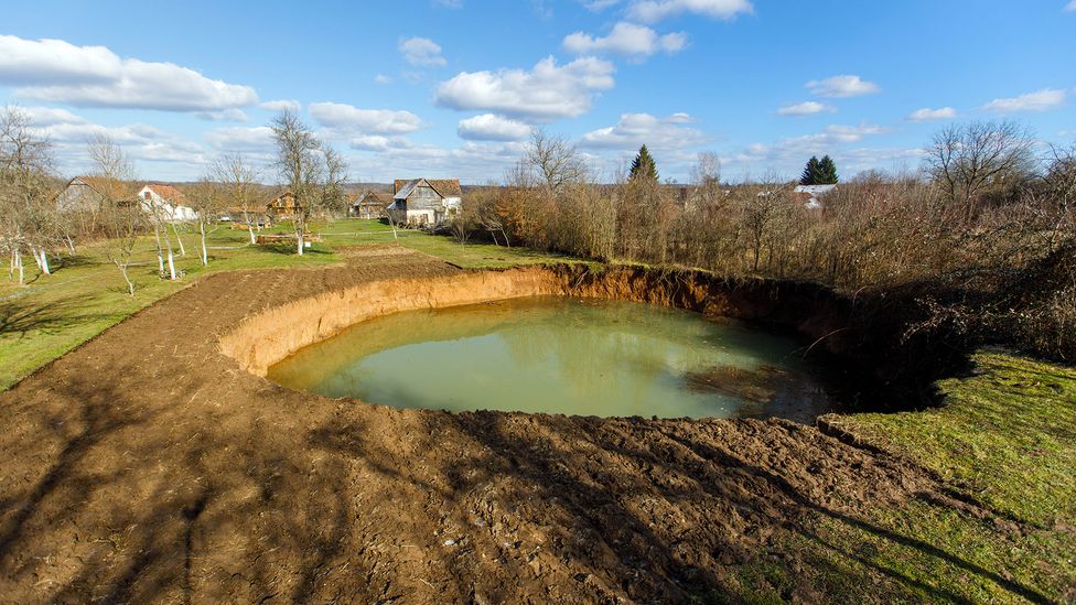 The hole that opened up in Nikola Borojević's garden was more than 30m (98ft) wide and 15m (49ft) deep (Credit: Antonio Bronic/Reuters/Alamy)