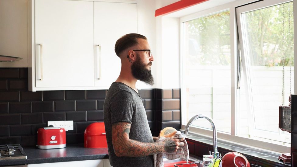 Man staring out of his window