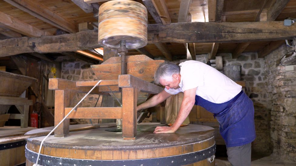 Gerard Lhuillier makes flour from a water mill that was constructed around 1741 (Credit: Anna Muckerman)