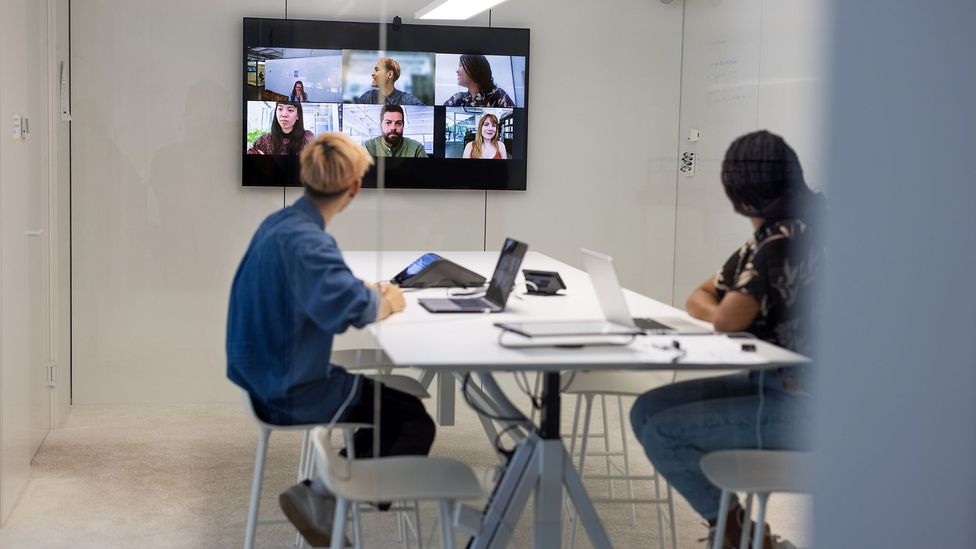 A mix of some team members working remotely and others in the office can lead to miscommunication, less collaboration and other problems, experts say (Credit: Getty Images)