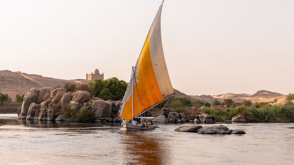 Sailboats pass over the shimmering Nile river (Credit: Mai Farouk)