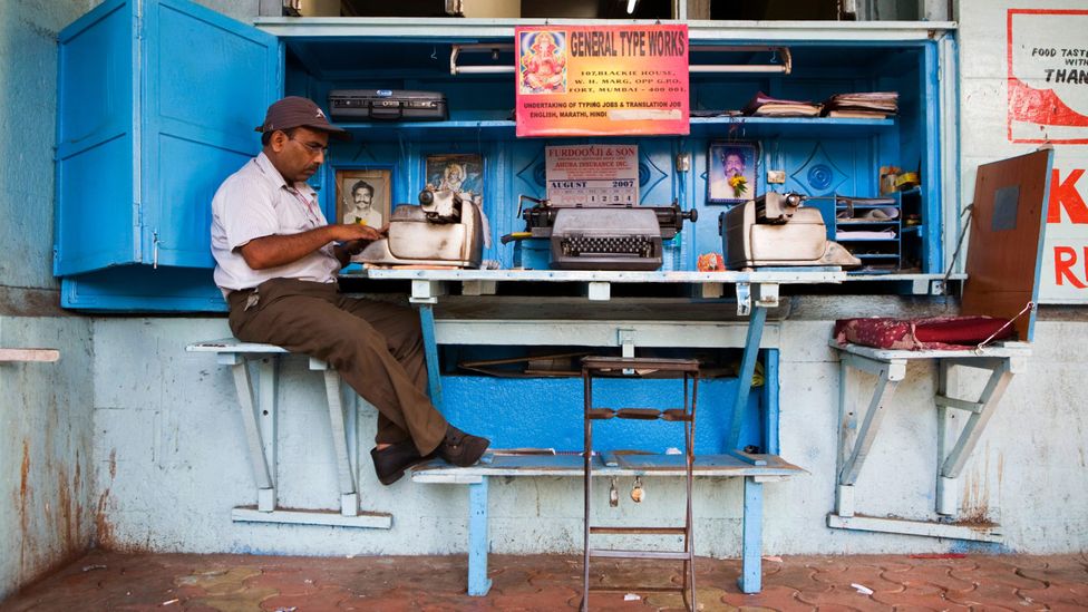 A typist typing on a typewriter in Mumbai, India (Credit: Alamy)