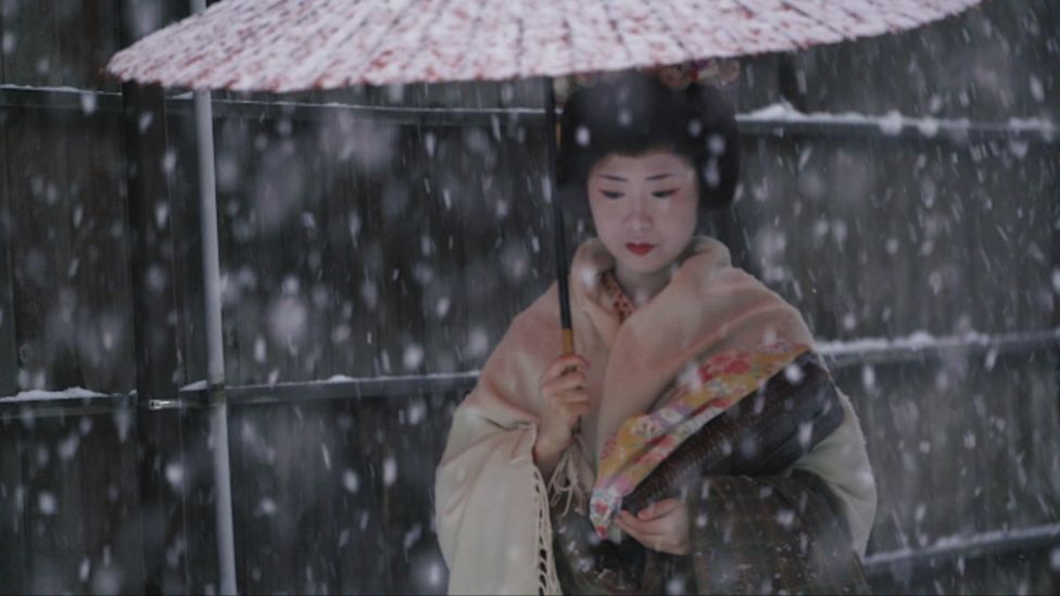 Geisha walking in the snow in Niigata City, Japan