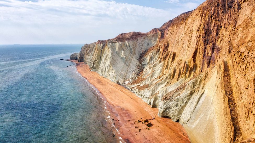 The island glows in shades of red, yellow and orange due to the more than 70 minerals found here (Credit: Lukas Bischoff/Alamy)