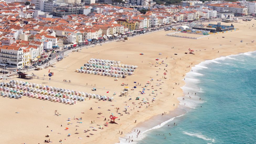 Nazaré has long been a popular summer holiday spot, but is now also the epicentre of big wave surfing (Credit: Fernando Trabanco Fotografía/Getty Images)