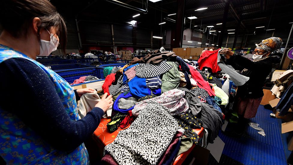 Due to the complex mixture of materials in modern fabrics, recycling clothing is currently a labour intensive task (Credit: Georges Gobet/Getty Images)